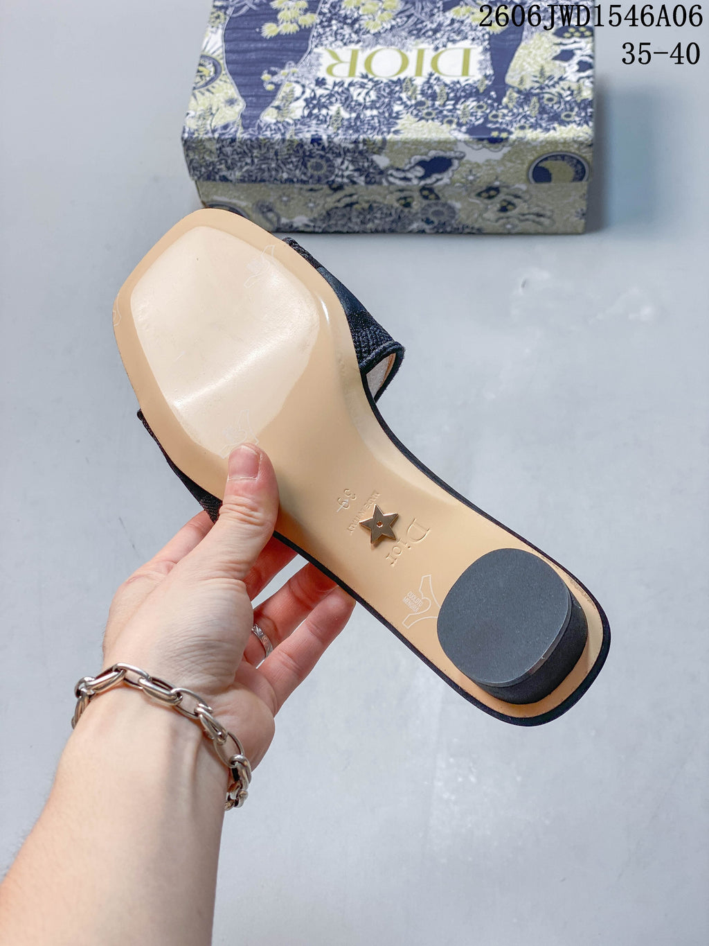 Underside of a mule sandal showing the sole and cylindrical heel