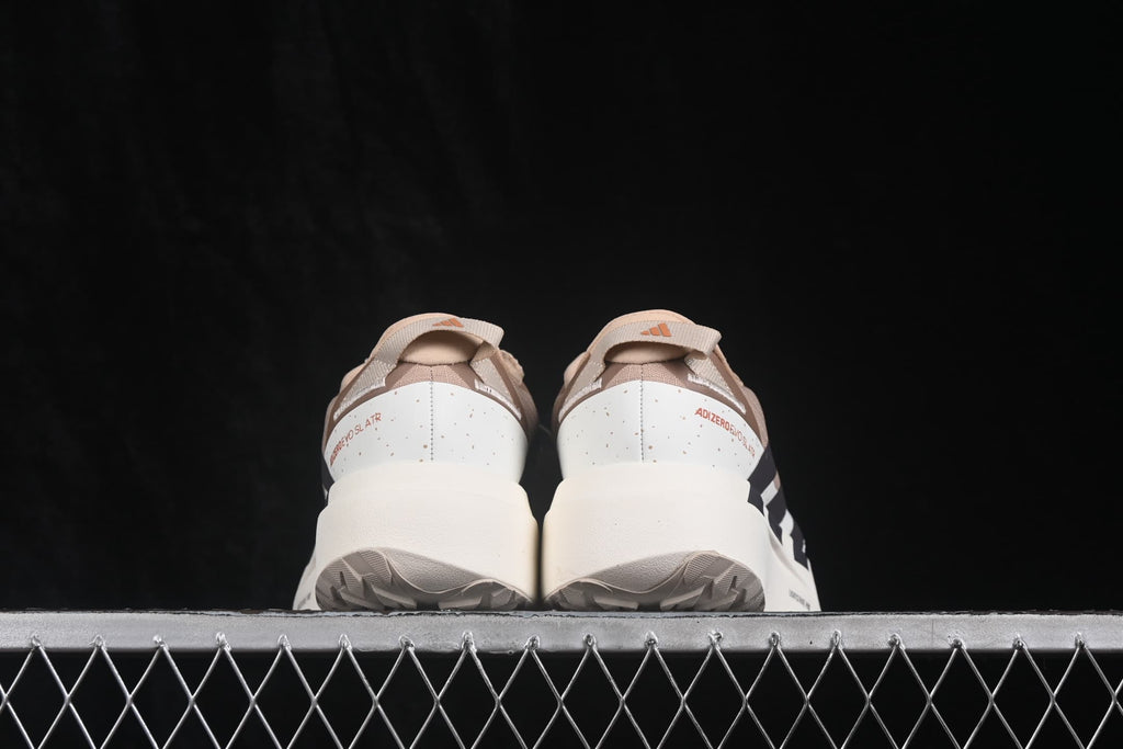 Rear view of the beige and cream Adidas Adizero Evo SL running shoes with model lettering on the heel.