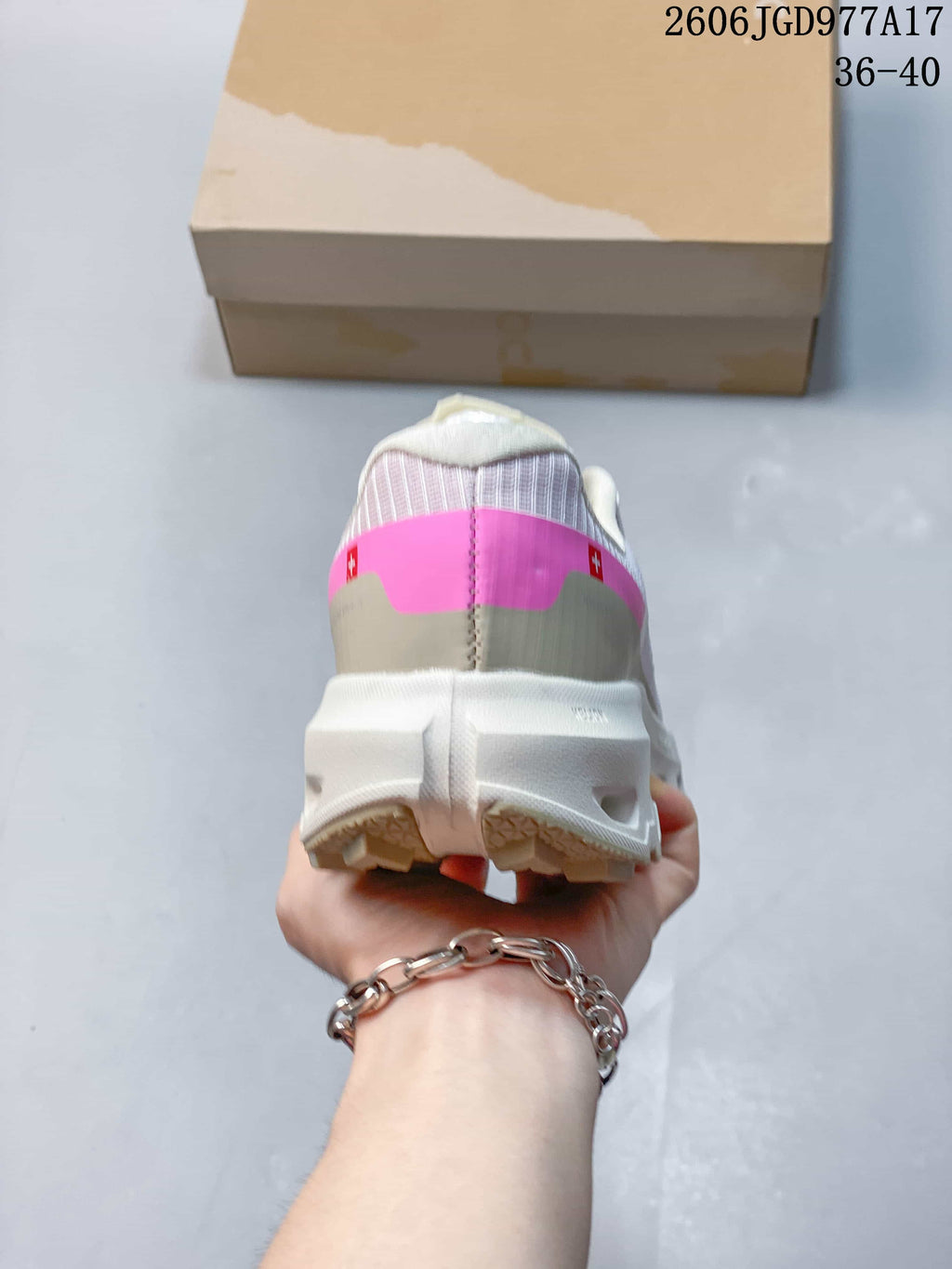 Rear view showing the pink heel accent and thick sole.