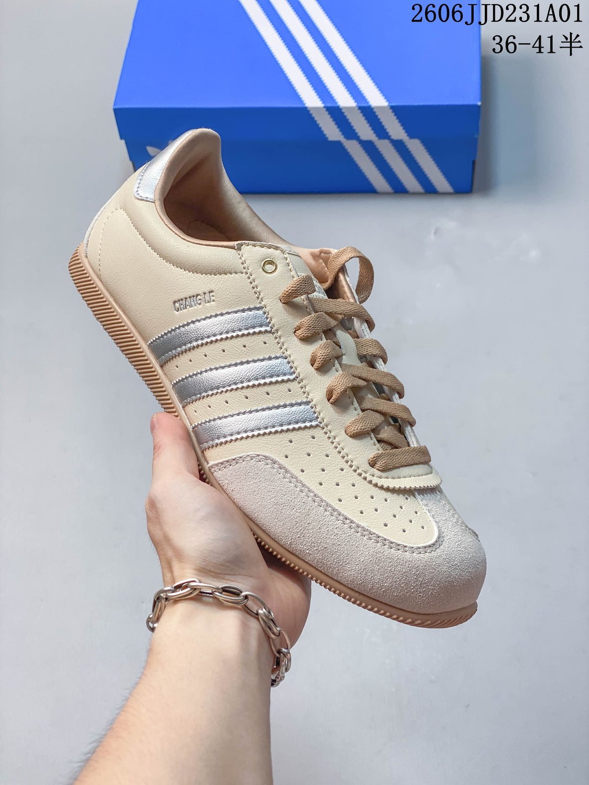Angled side view of a cream Adidas Originals Changle sneaker with silver stripes and suede-look toe overlay