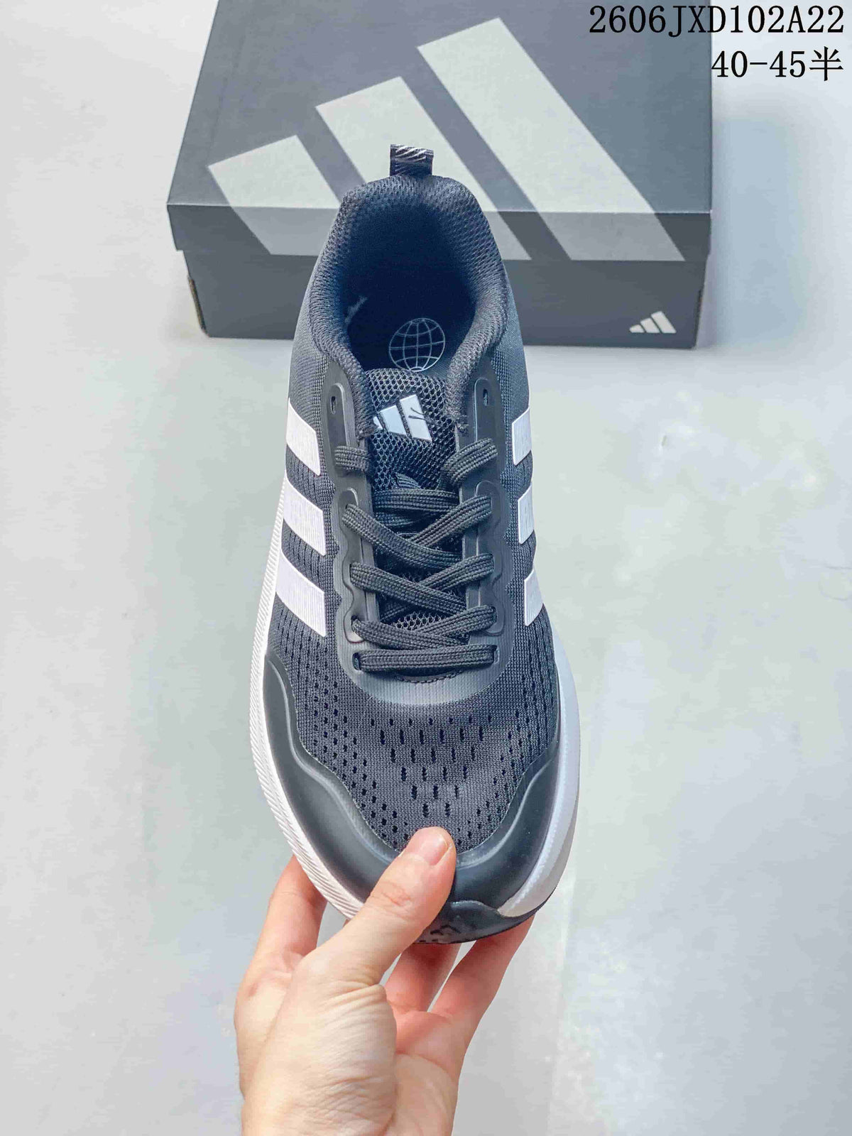 Front view of a navy lace-up sneaker with white stripes.