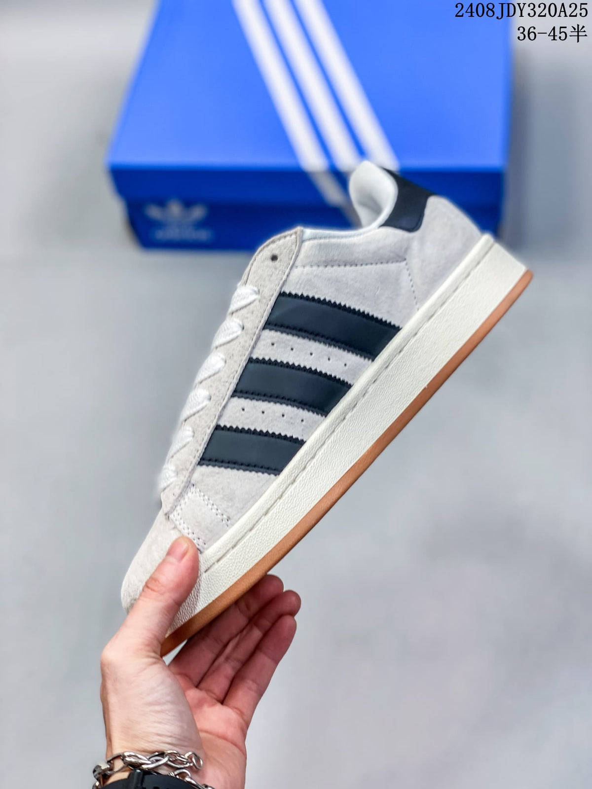 Side view of a light gray Adidas Campus 00s sneaker with black stripes and a gum outsole