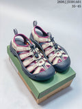 Pair of beige and plum KEEN Newport H2 sandals with dark gray soles, shown on a shoe box.