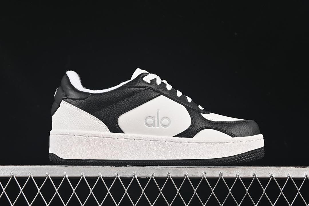 Side profile of the low-top sneaker in black and white