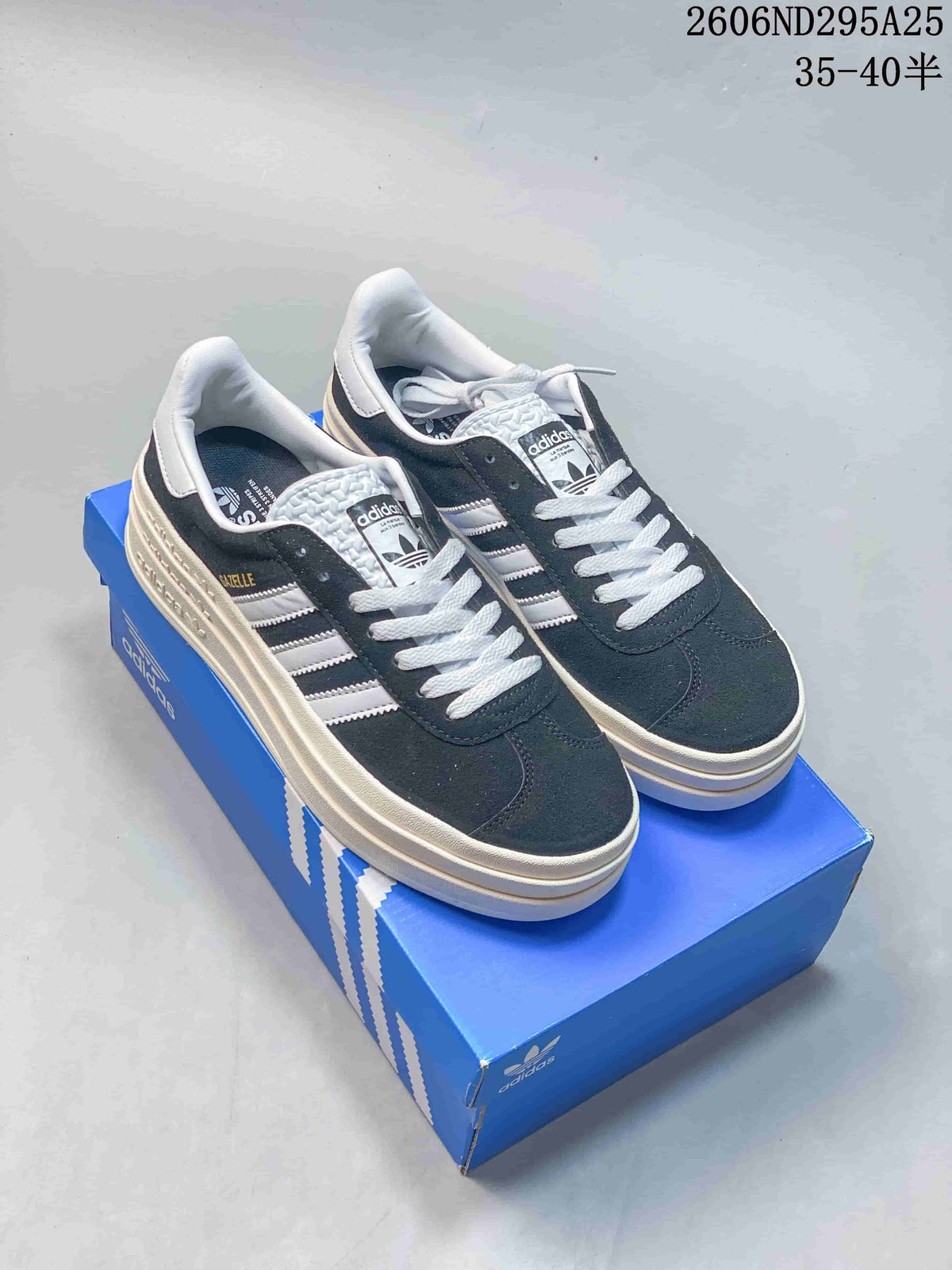 Dark blue Adidas Gazelle Bold W sneakers with white stripes and a layered off-white platform sole, shown on a blue box.