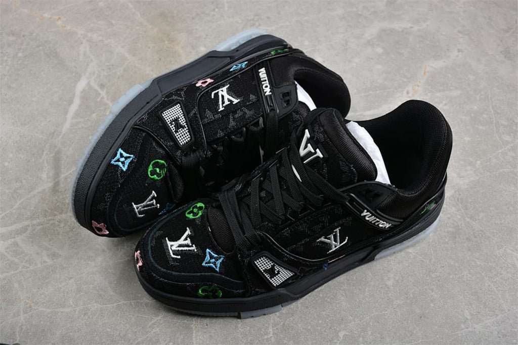 Pair of black low-top sneakers showing patterned uppers and multicolor motifs