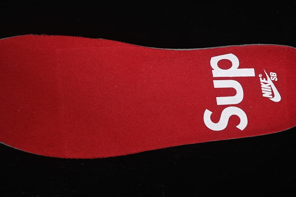 Red insole printed with Supreme and Nike SB branding