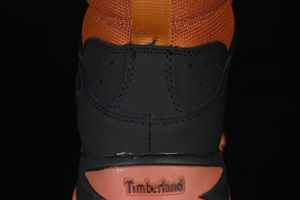 Rear view showing the boot collar, pull loop, and heel branding