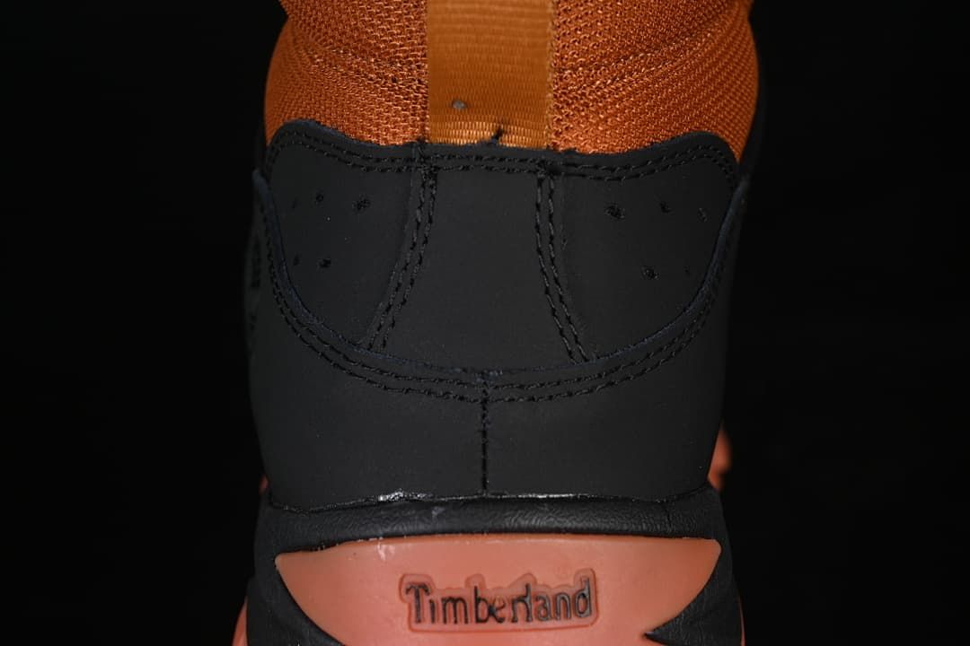Rear view showing the boot collar, pull loop, and heel branding