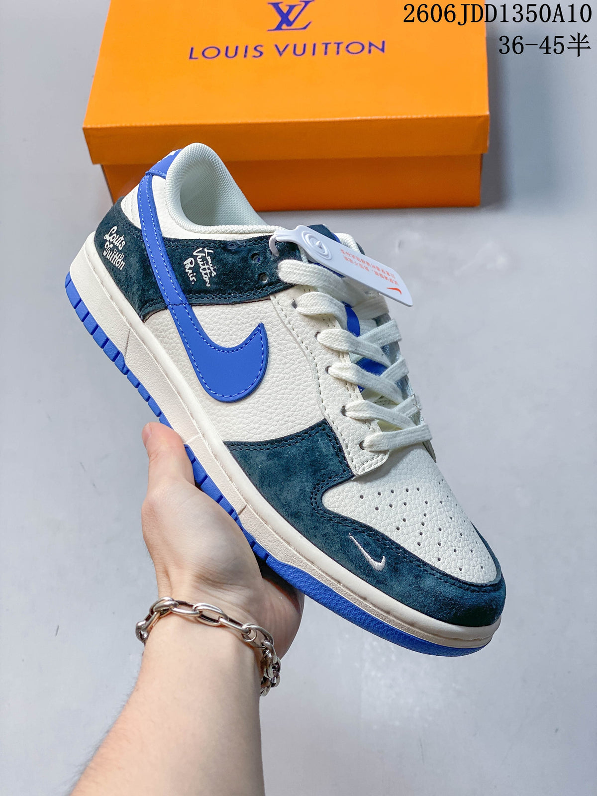 Angled side view of a white, teal and blue low-top sneaker