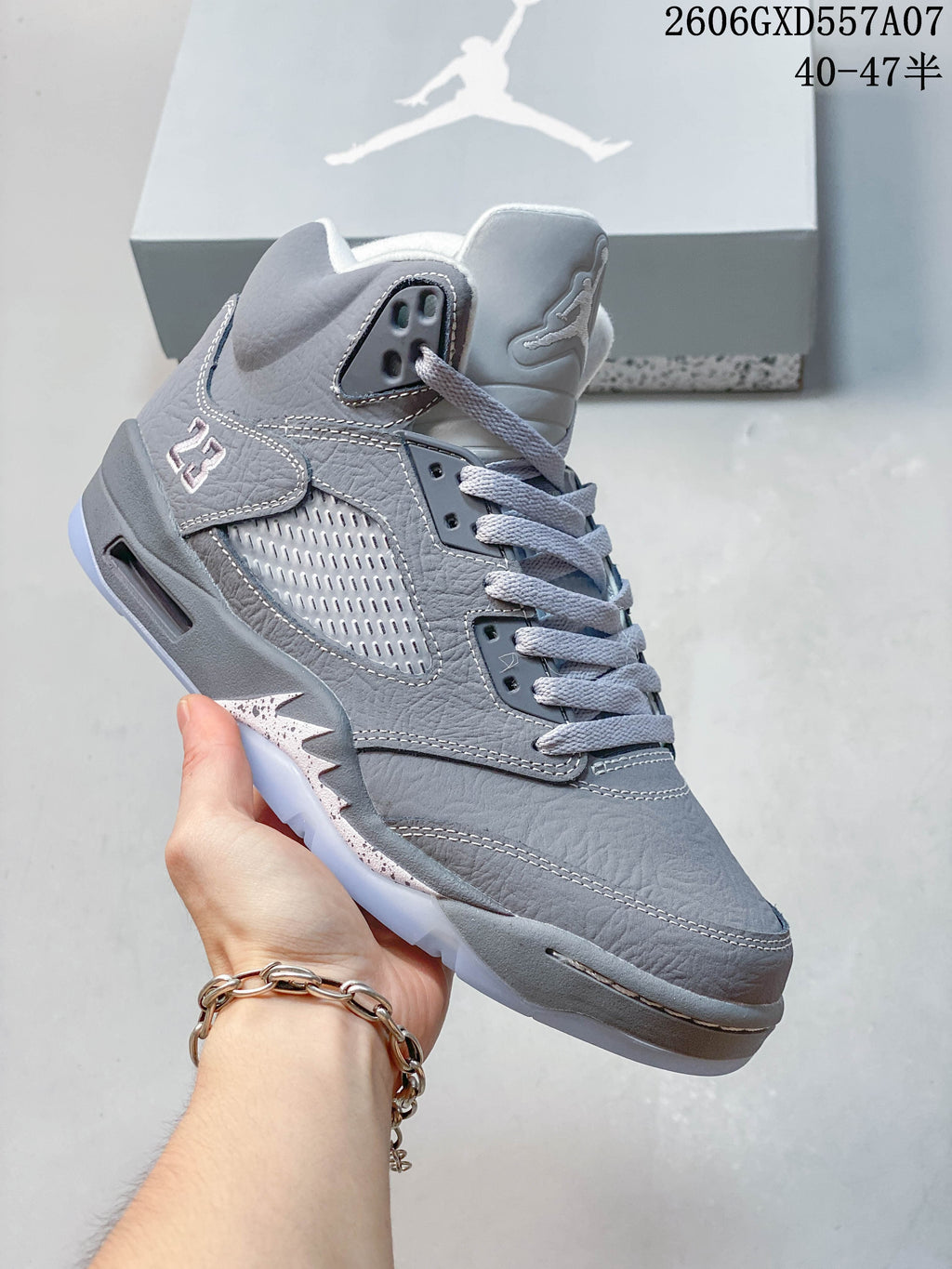 Angled view showing the gray upper, side mesh panel, and translucent-looking outsole