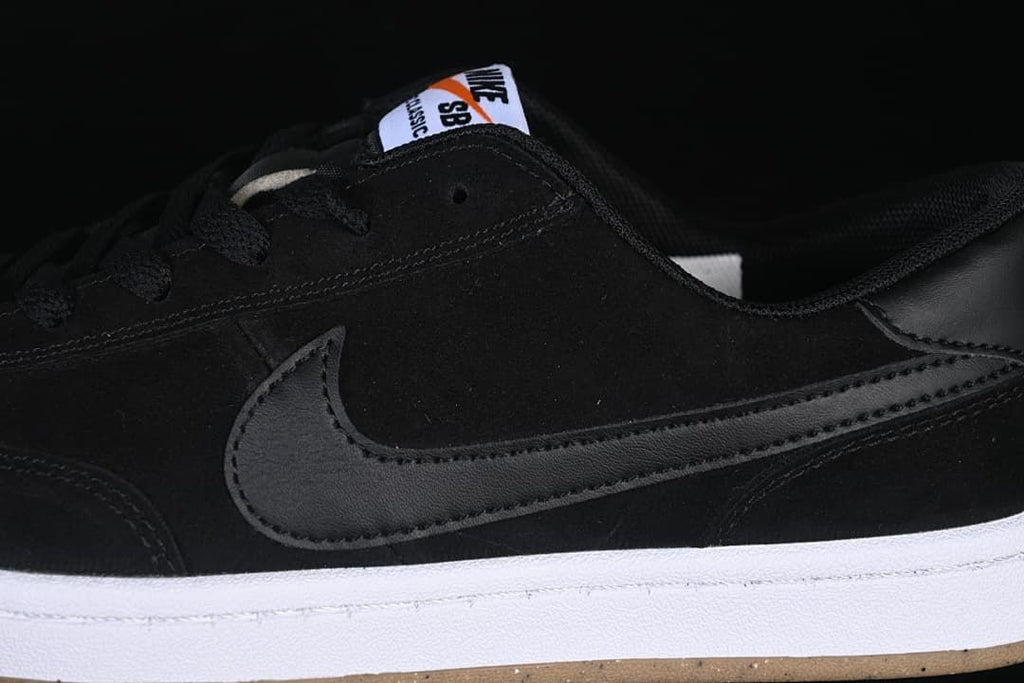 Detail of the black side Swoosh, upper and white midsole.
