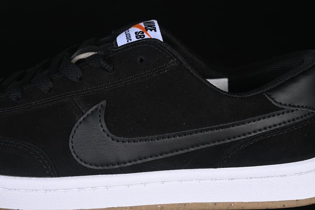 Detail of the black side Swoosh, upper and white midsole.