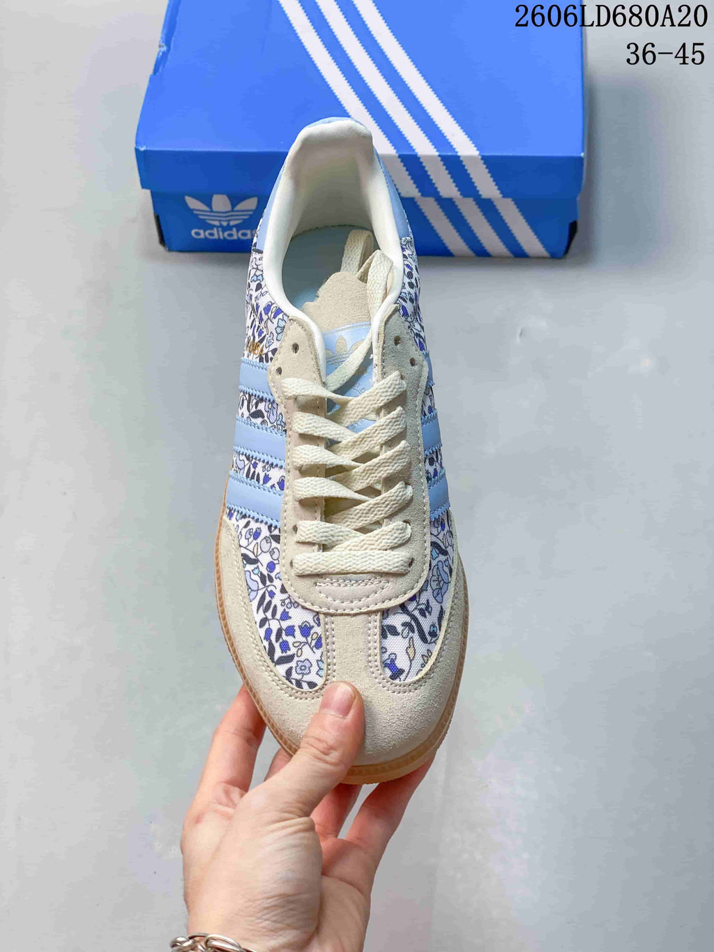 Top view of the sneaker showing cream laces and floral-print panels.