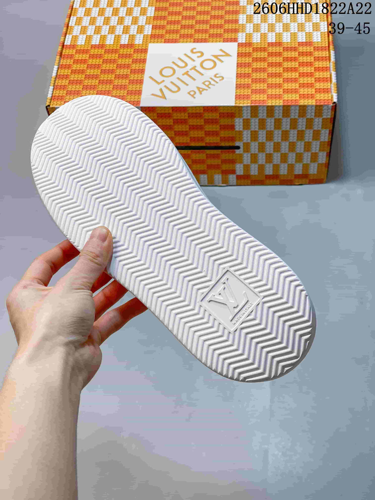 Underside of the sneaker showing a chevron-patterned tread
