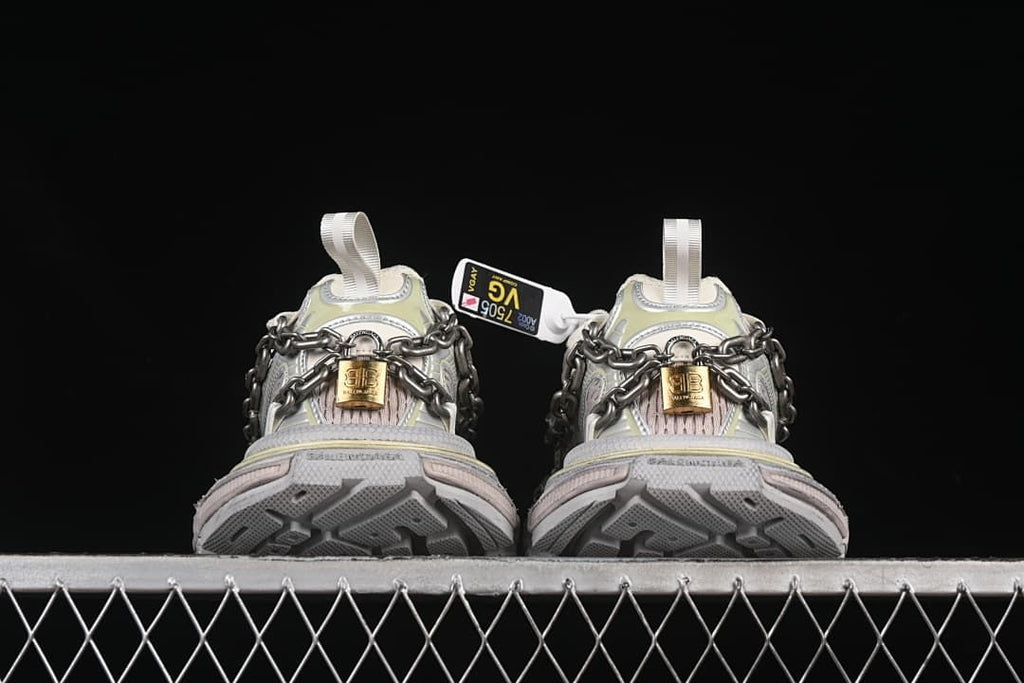 Rear view of both shoes showing the outsole tread and chain details.