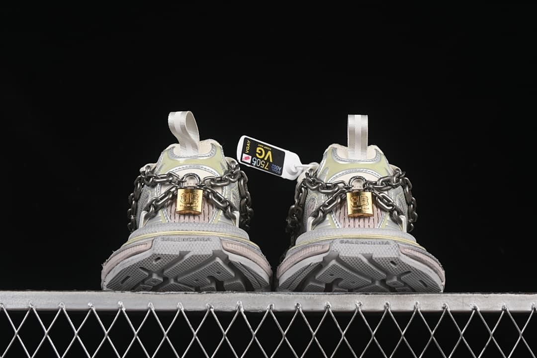 Rear view of both shoes showing the outsole tread and chain details.