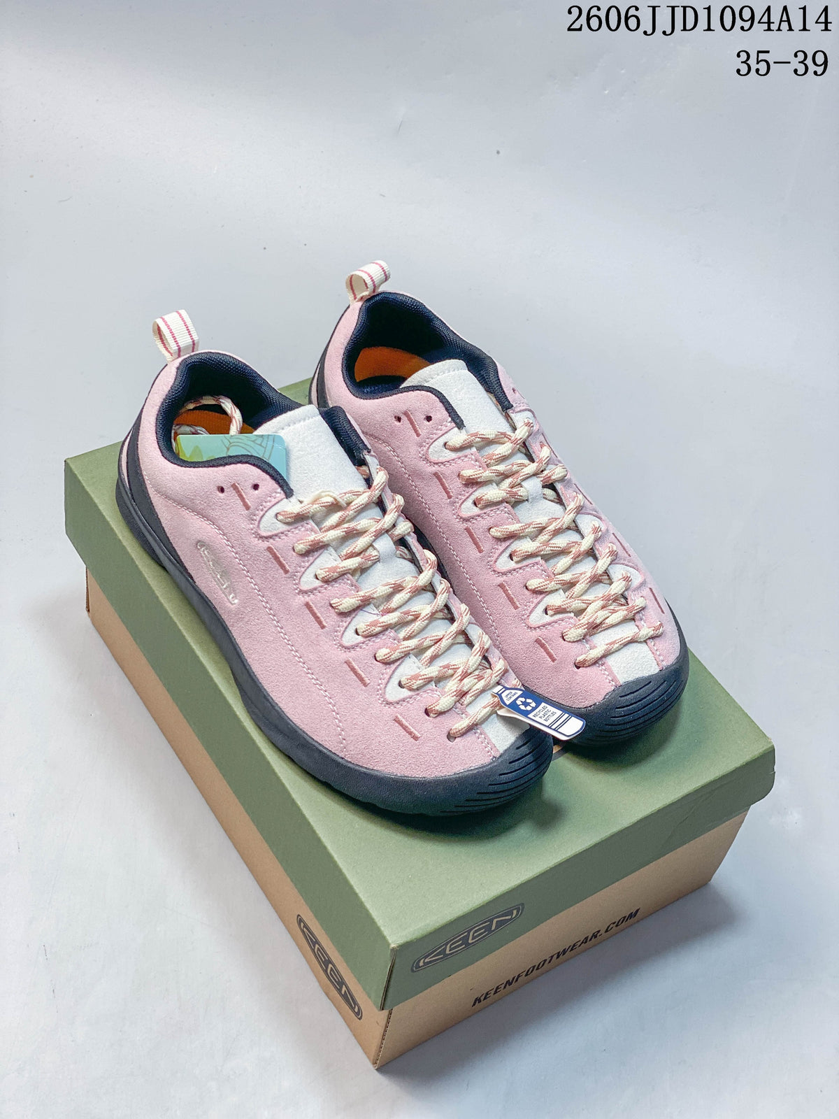 Pair of pink KEEN Jasper low-top sneakers with cream patterned laces on a shoebox