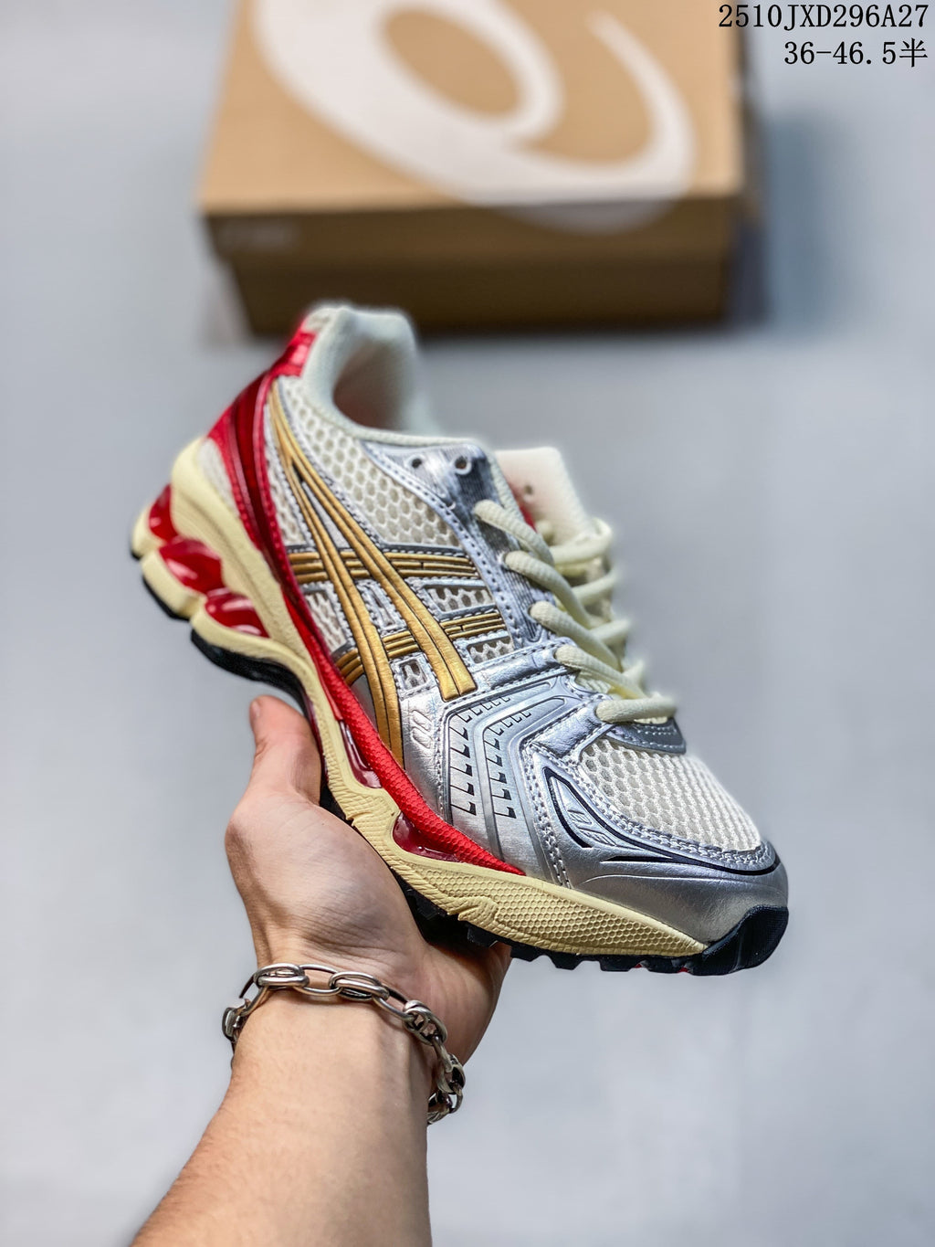 Silver and white mesh sneaker with gold and red accents, held in hand.