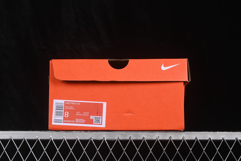 Orange Nike shoe box showing a Nike Free 3.0 label, style code 816568 005, and a photographed sample size of US 8, UK 7, EU 41, and CM 26.