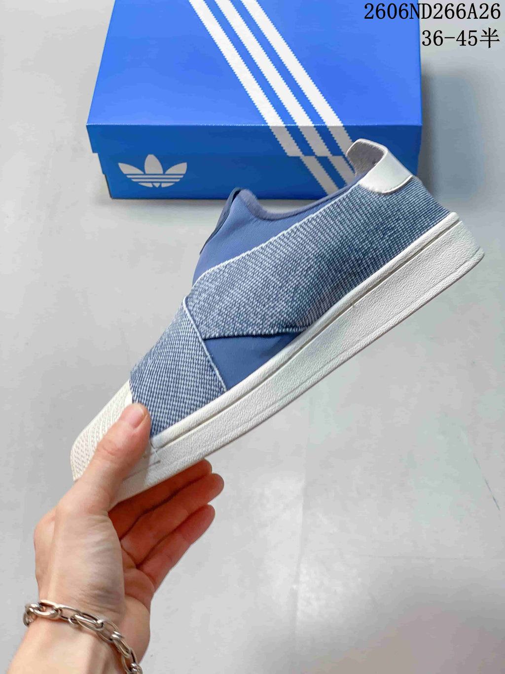 Side view showing the blue cross-over upper, textured panels, and white sole.