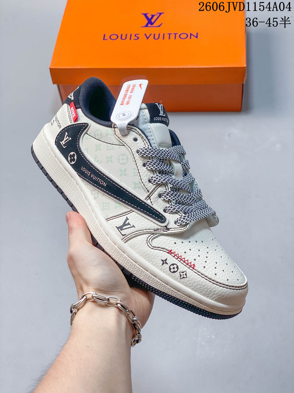 Angled side view of the off-white sneaker with pale patterned panels, navy accents and patterned laces.
