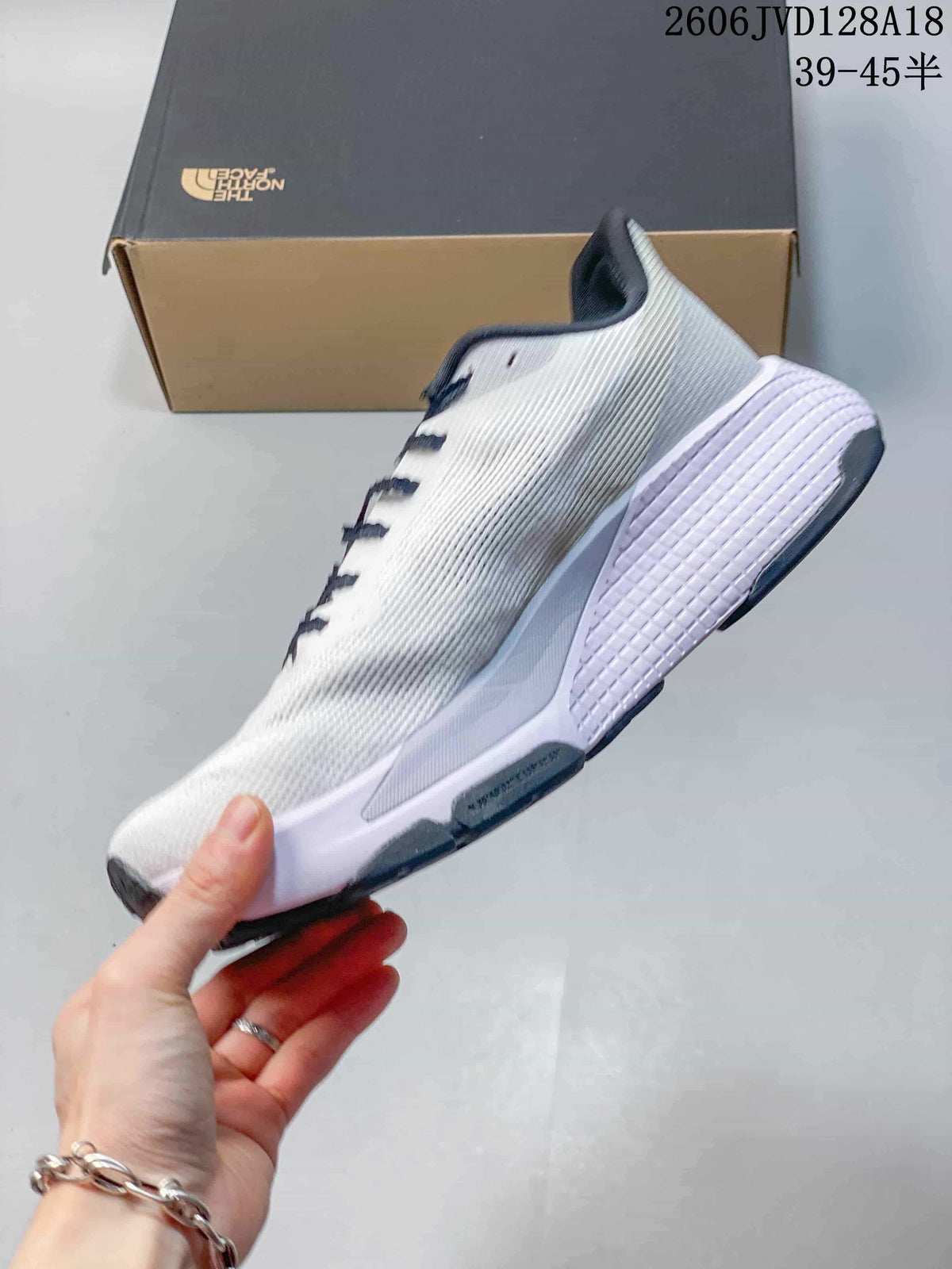 Side view of a white The North Face Alta Mesa 500 running shoe with navy details.
