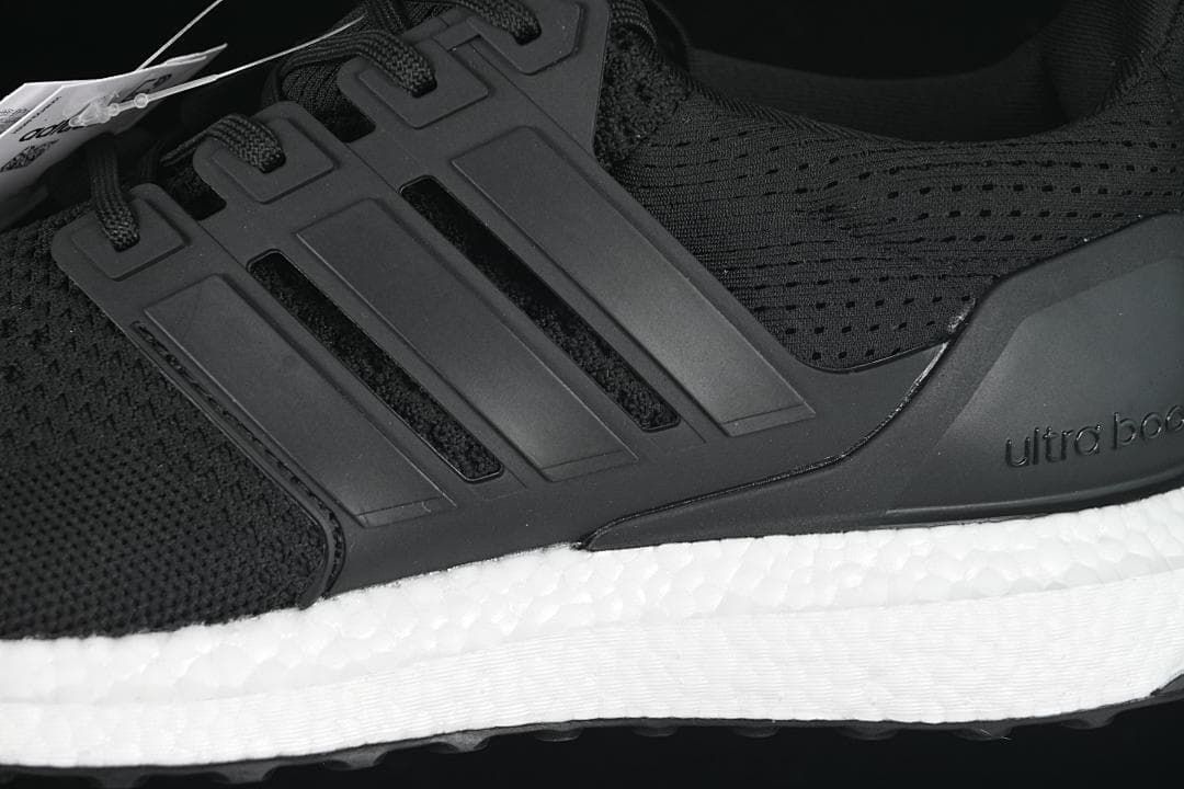Close-up of the black side cage, knit upper, and white midsole.
