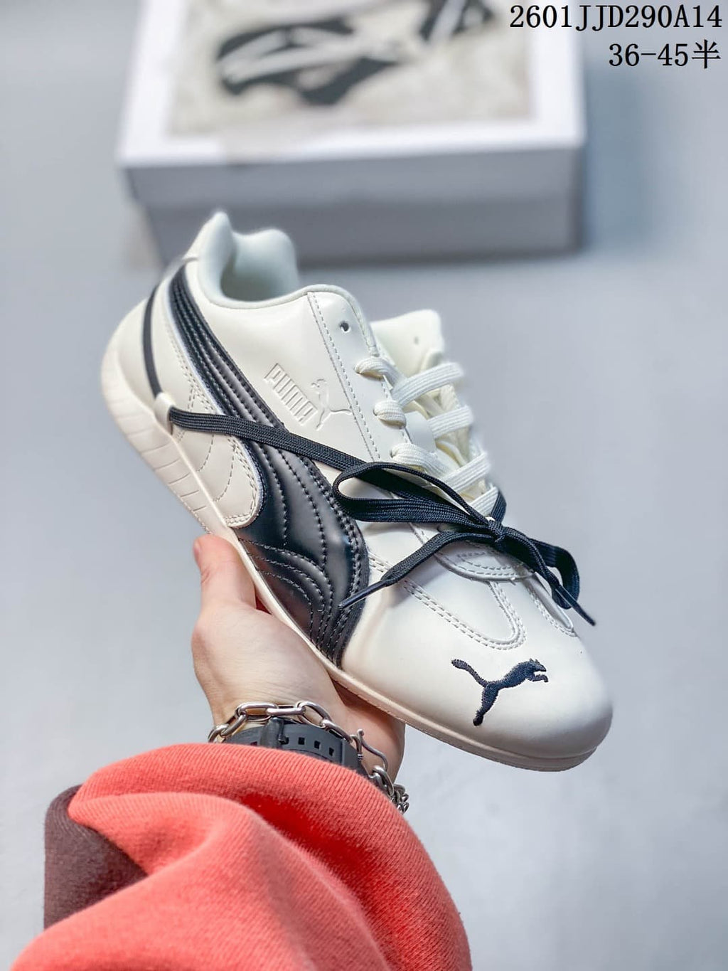 Side view of a cream PUMA Speedcat TTF sneaker with navy side stripes and laces.