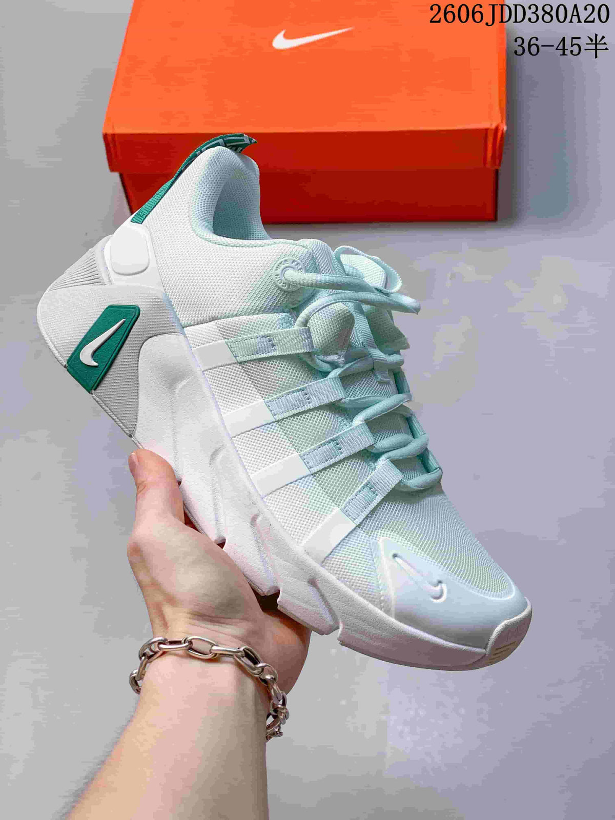 Light shoe with pale green accents and a sculpted sole