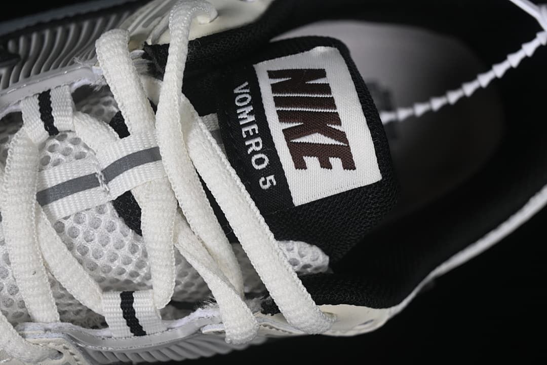 Close-up of the tongue label reading Nike and Vomero 5.