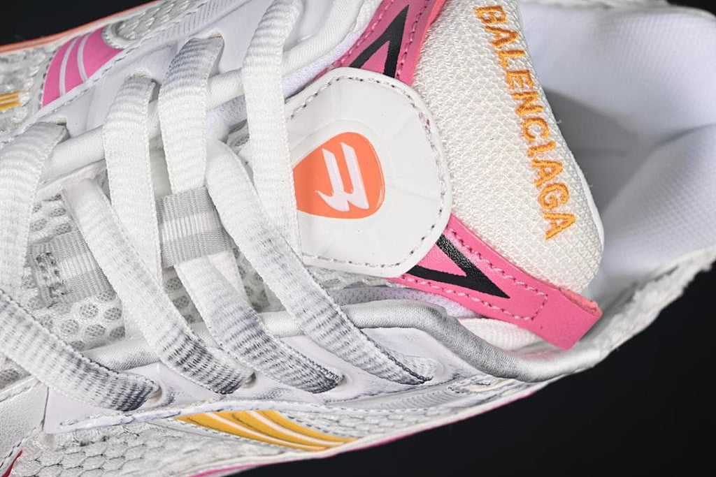 Close-up of laces, tongue, and pink and orange accents