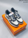 Pair of white and charcoal Nike Air Force 1 Low-style sneakers with patterned panels and mixed-tone laces