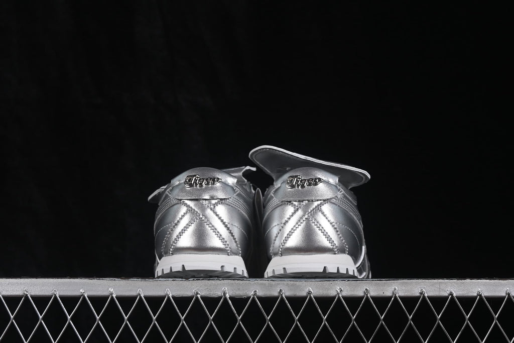 Rear view of silver Onitsuka Tiger Mexico 66 Golf sneakers showing the heel branding and textured outsole.