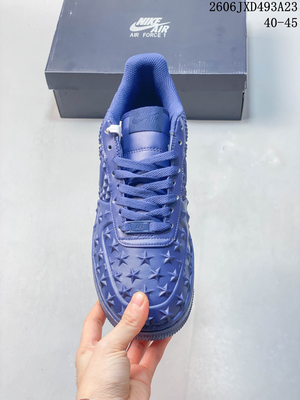 Front view of a blue Nike Air Force 1 sneaker with star-patterned toe and matching laces