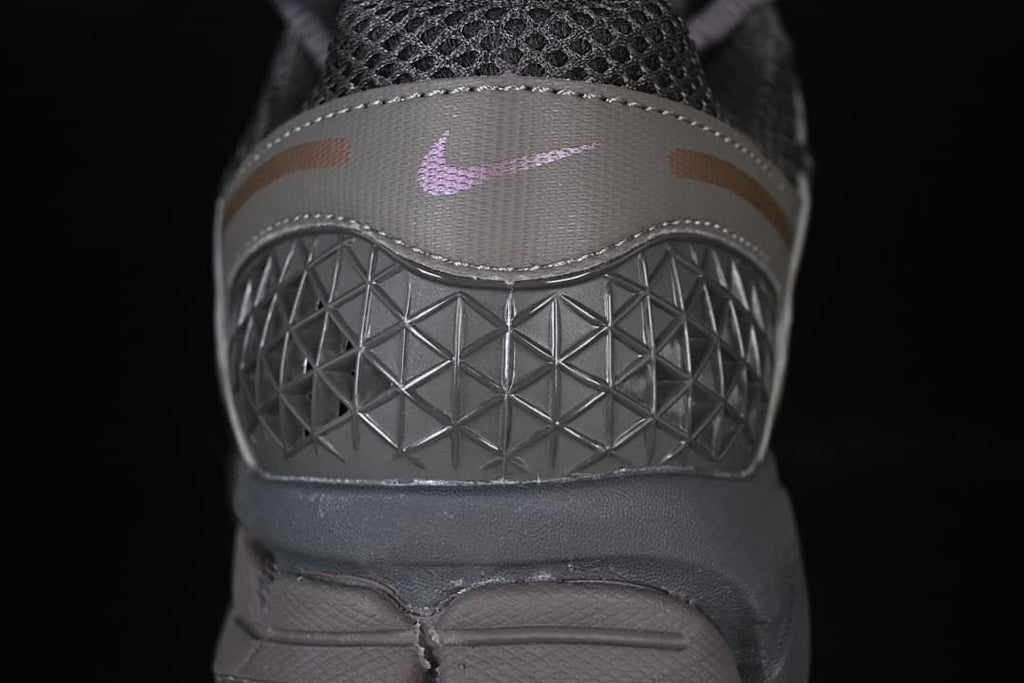 Rear view showing geometric heel detail and small pink Swoosh