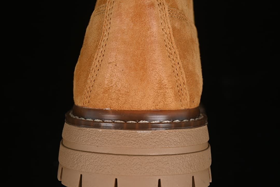 Rear view showing the boot's stitched heel and layered outsole