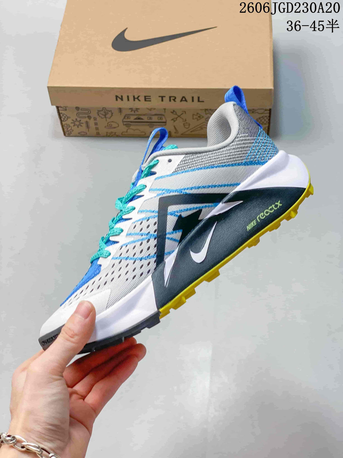 Side view of a white Nike Wildhorse 10 trail shoe with blue details, a dark side panel, and yellow outsole lugs.