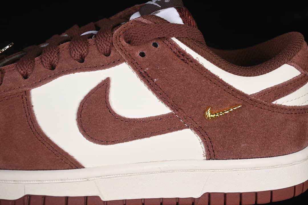 Close-up of brown and white side panels and gold-tone mini Swoosh