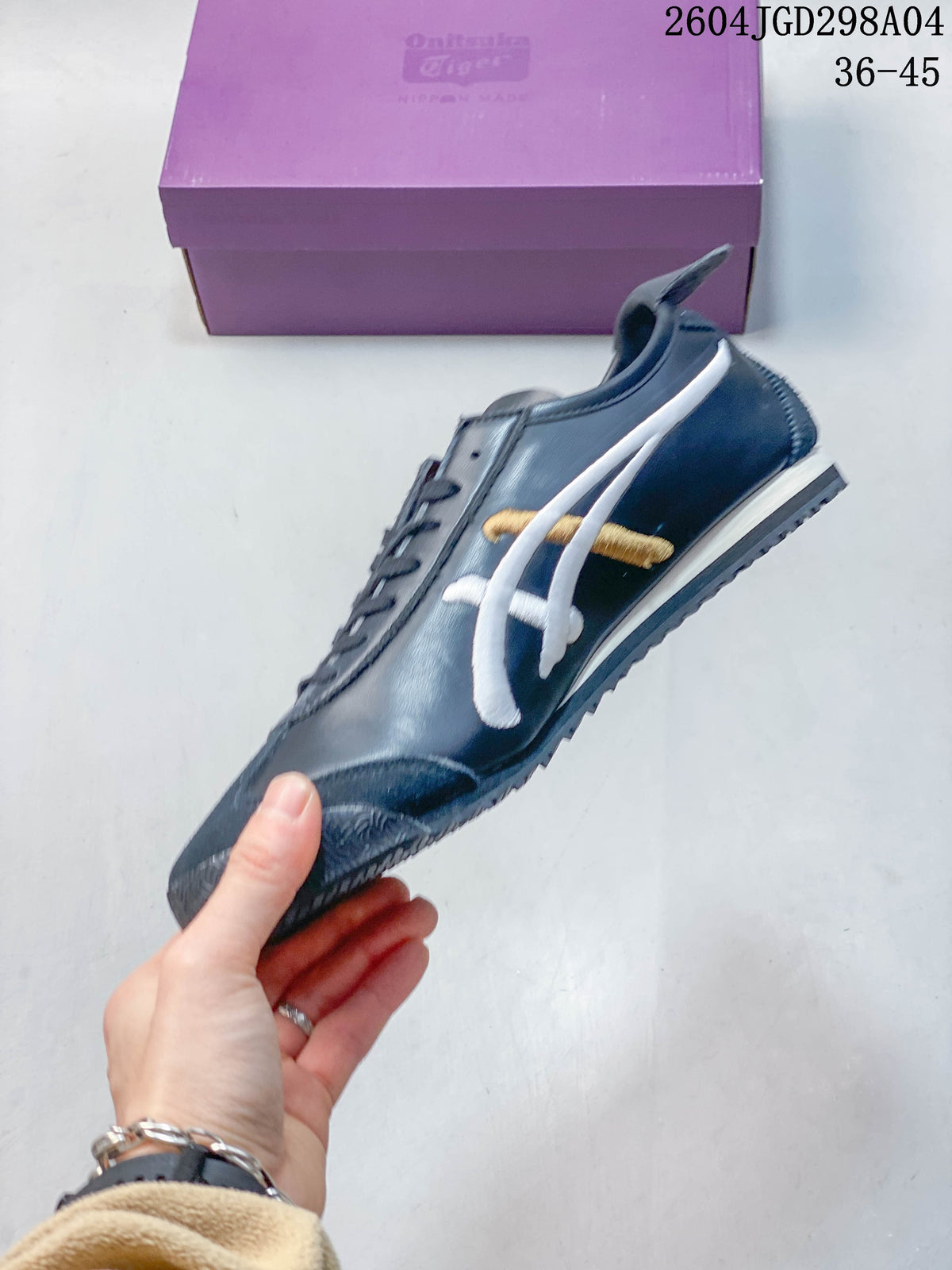 Side profile of a navy Onitsuka Tiger Mexico 66 Deluxe sneaker with white and gold stripes
