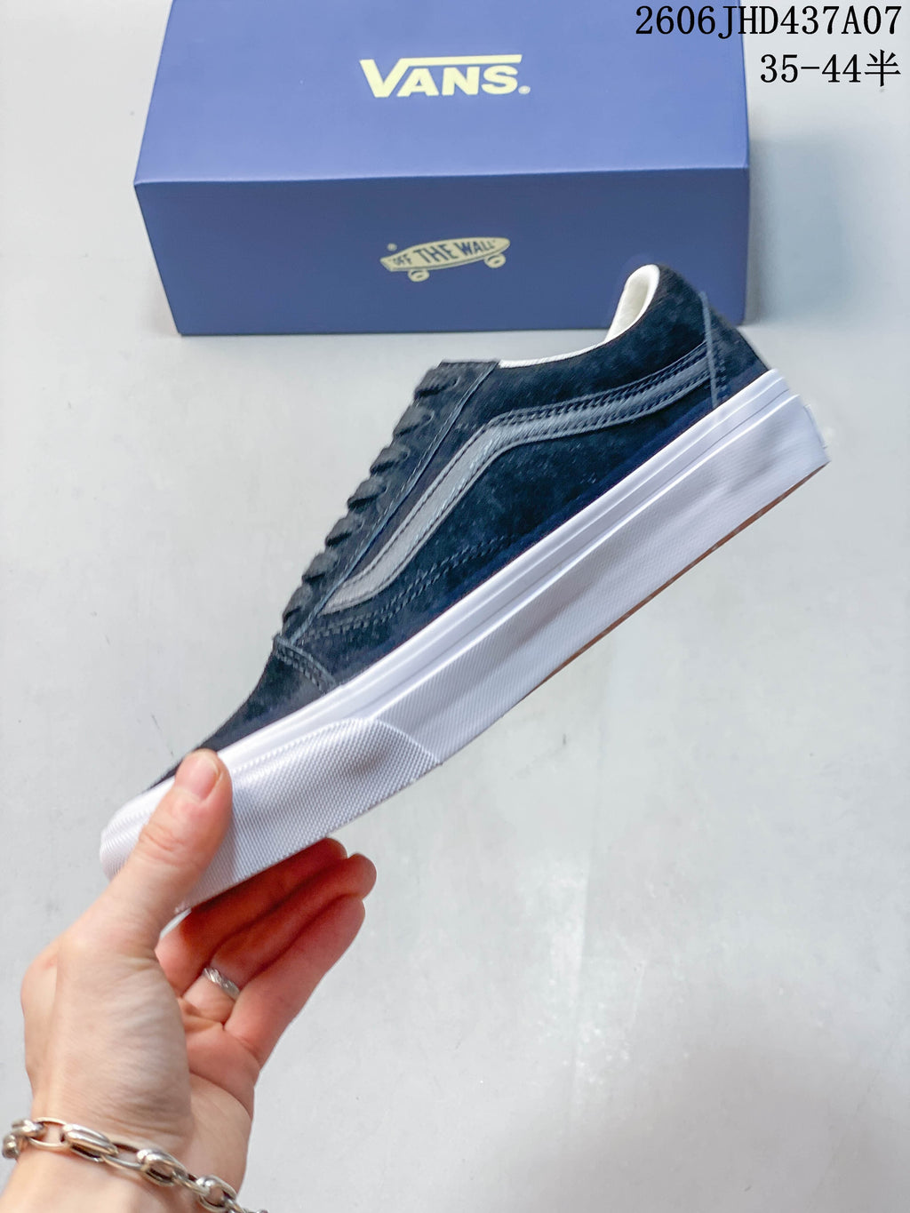 Side view of a navy Vans Old Skool 36 sneaker with a contrasting stripe