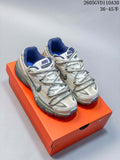 Pair of cream, silver-toned and blue Nike Initiator sneakers on an orange shoebox