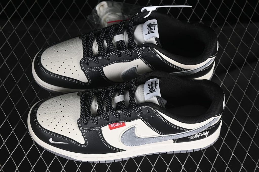Pair of black, white, and grey low-top sneakers shown from above