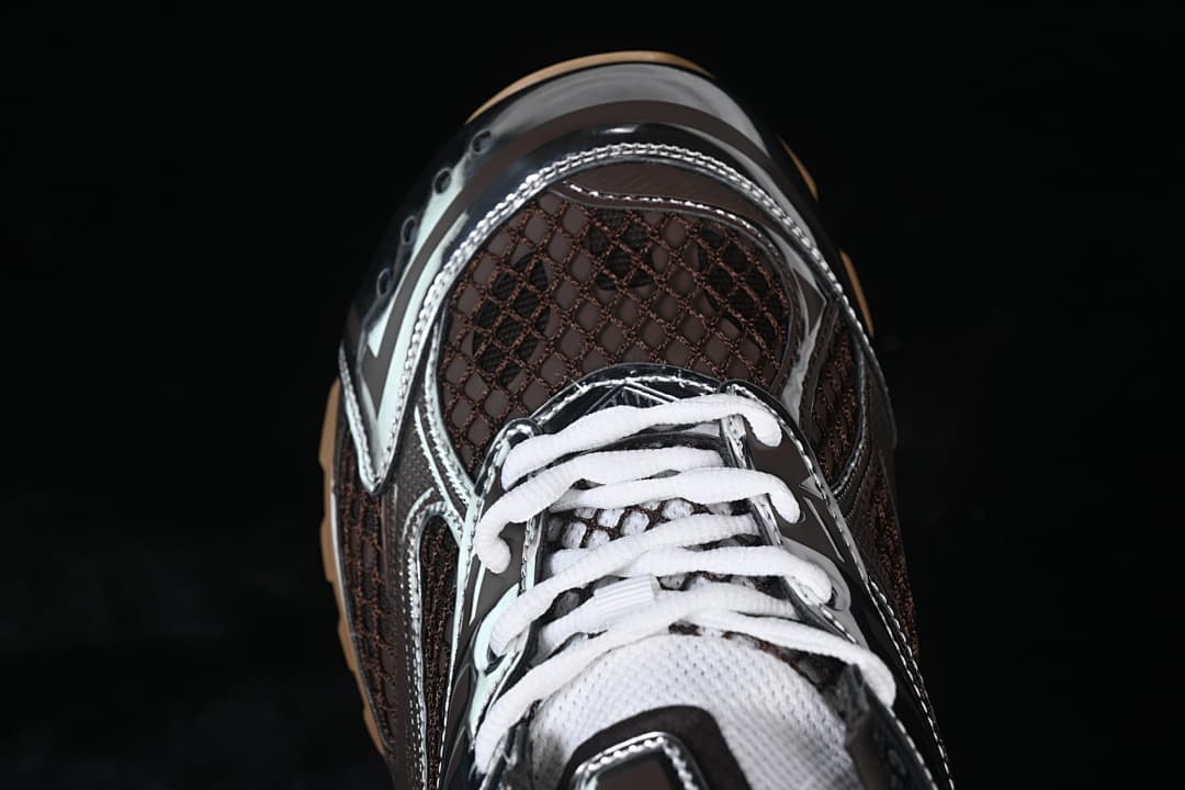 Top-down view of the sneaker's brown mesh-patterned toe and white laces.