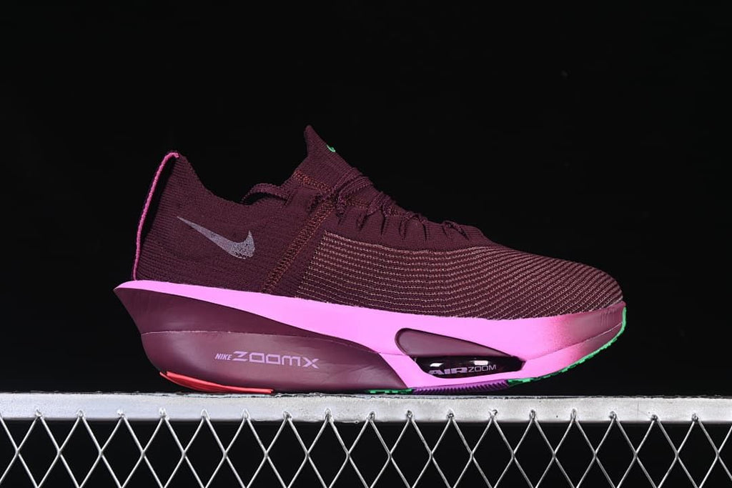 Side view of the burgundy shoe with pink midsole and visible cushioning details
