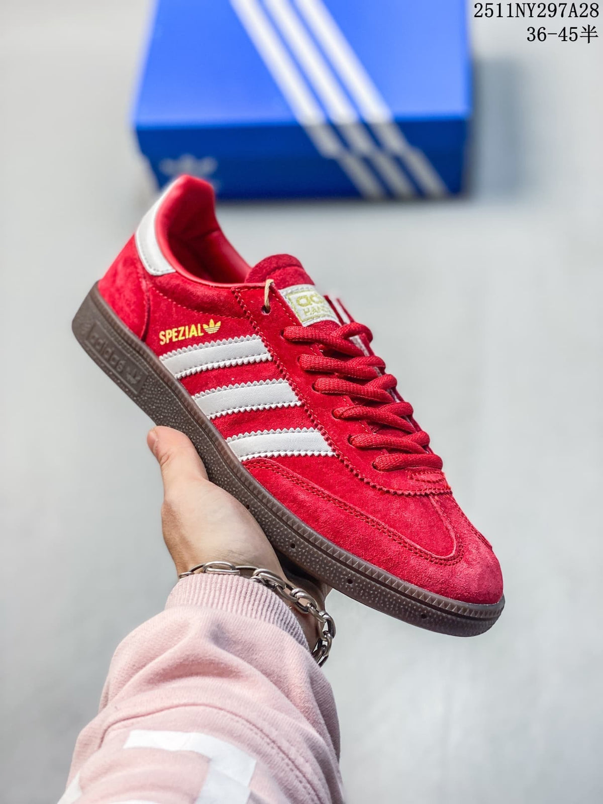 Red Adidas Spezial-style sneaker with white stripes and dark outsole