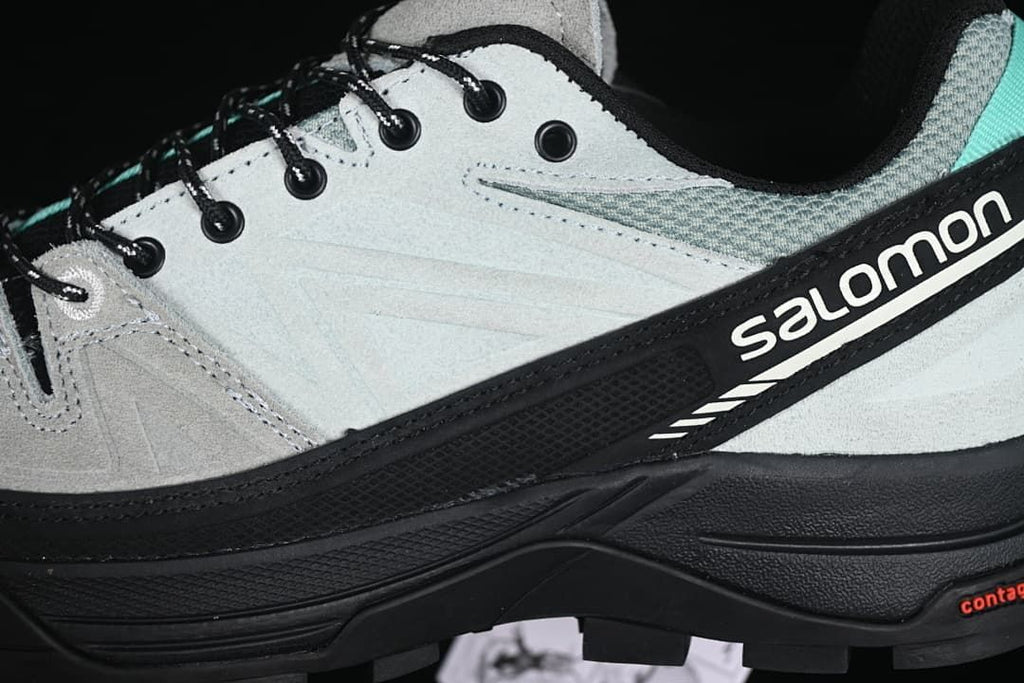 Close-up of the side branding, lace eyelets, and layered upper.
