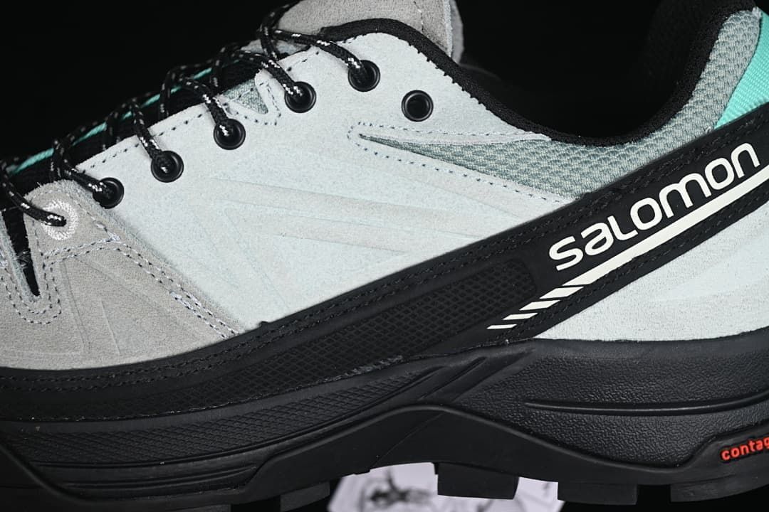 Close-up of the side branding, lace eyelets, and layered upper.