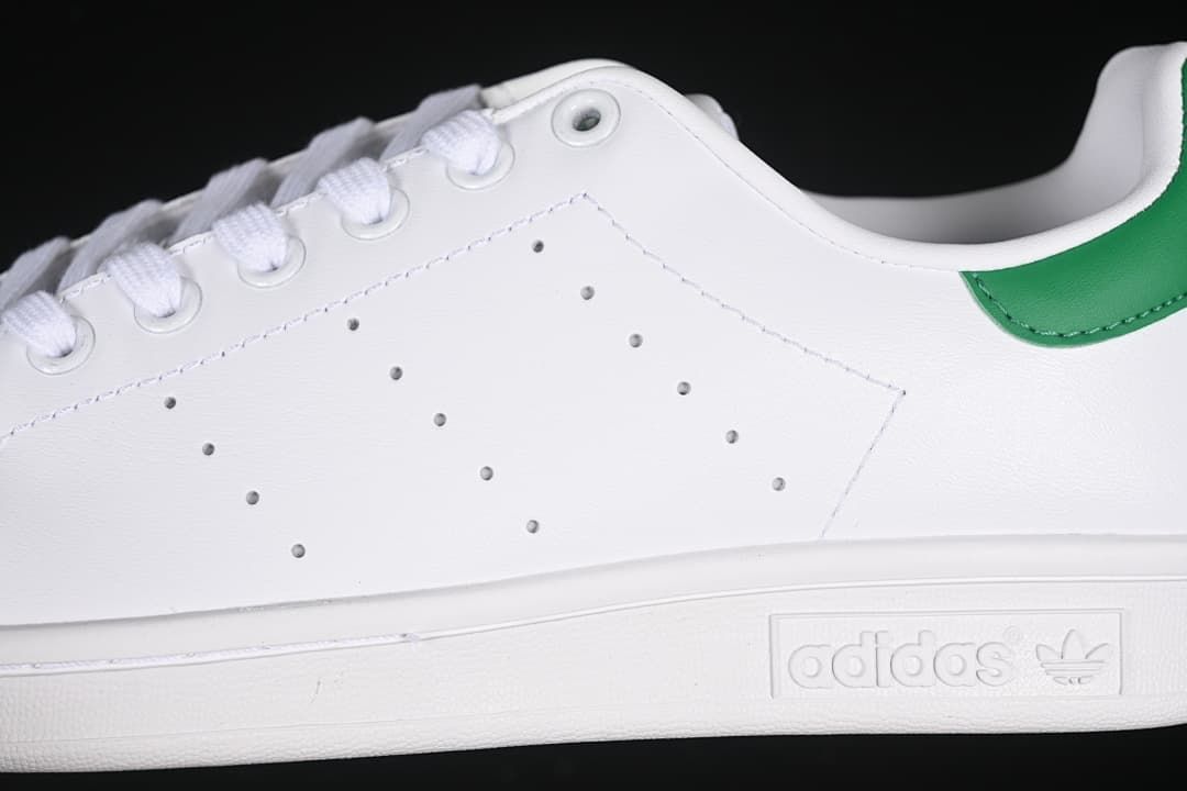 Close-up of perforated side details, stitching, and midsole branding