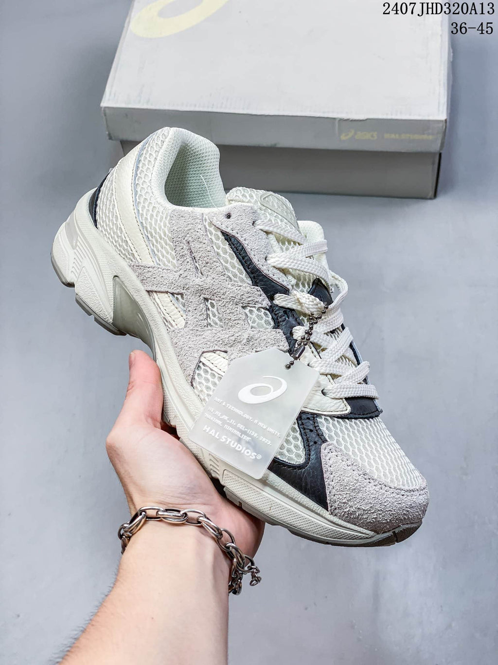 Angled side view of the cream and gray ASICS GEL-1130 sneaker